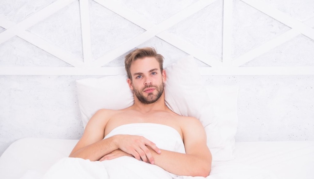 uomo a letto che ha utilizzato integratori sessuali